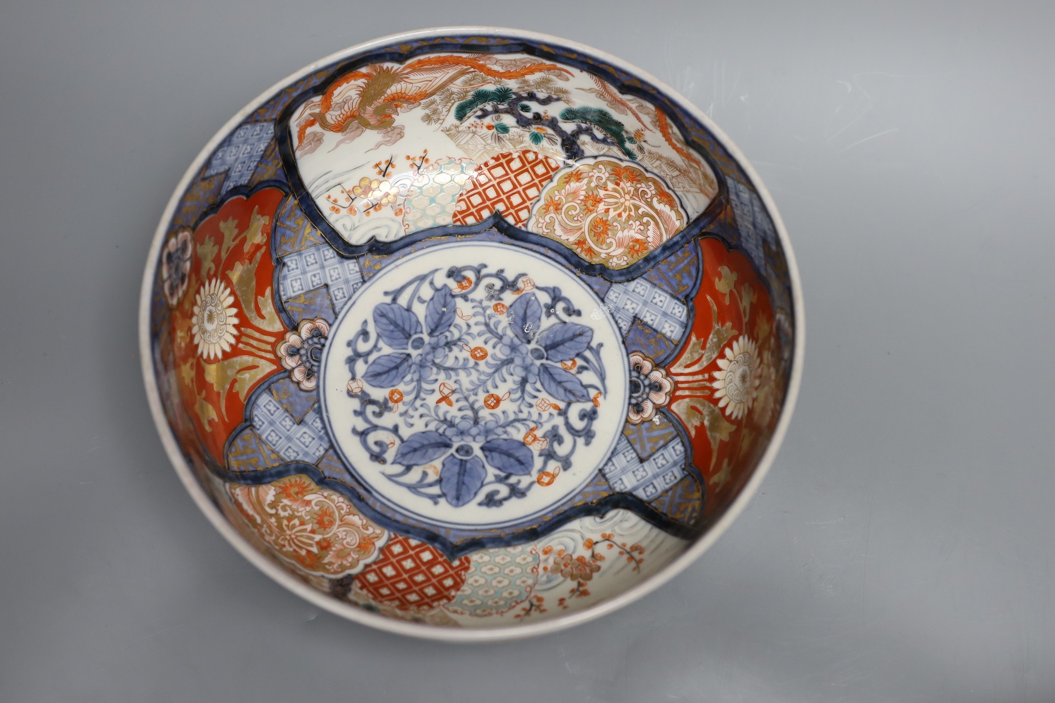 An 18th century Japanese Imari dish (af), another Imari dish, an 18th century Chinese export bowl (af) and a Chinese sang de boeuf vase, diameter of largest bowl 29cm